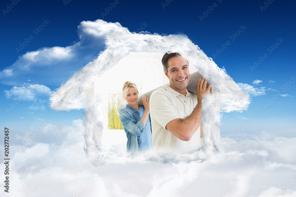 Couple carrying rolled rug after moving in a house against bright blue sky with clouds Couple carrying rolled rug after moving in a house against bright blue sky with clouds
