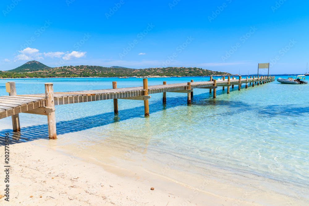 Wooden jetty on Santa Giulia beach, Corsica island, France