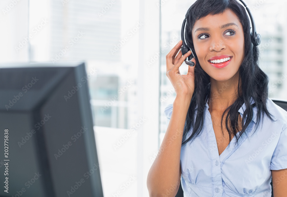 Attractive operator adjusting her headset Attractive operator adjusting her headset