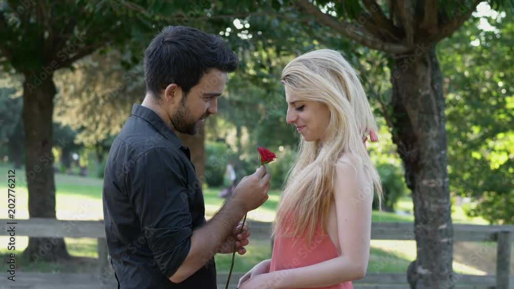Young Man Makes Marriage Proposal To blonde Woman In The Park Young Man Makes Marriage Proposal To blonde Woman In The Park