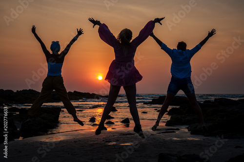 three cheerful women are jumping