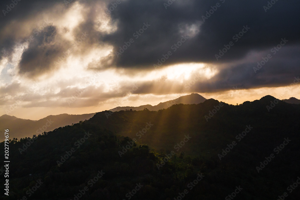 Aerial View of a Sun Beams, Clouds and Mountains at Sunset, in St. Lucia Aerial View of a Sun Beams, Clouds and Mountains at Sunset, in St. Lucia