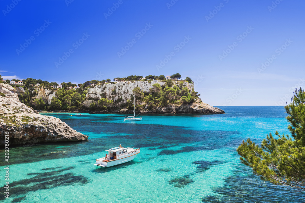 Beautiful bay with sailing boats and yachts, Cala Galdana, Menorca island, Spain. Yachting, travel and active lifestyle concept