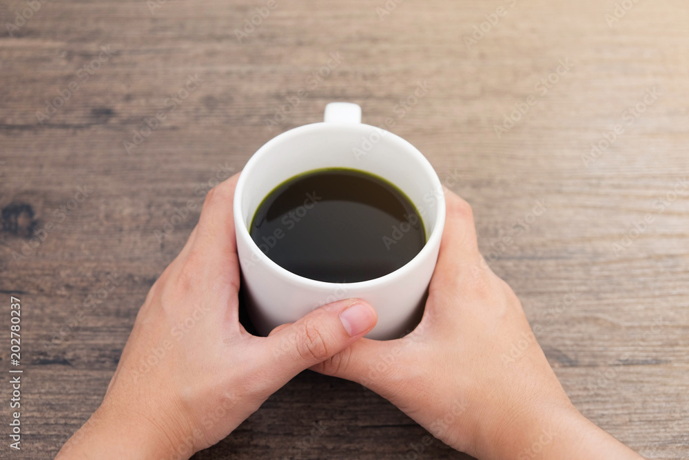 Cup of Matcha Green Tea in hand Cup of Matcha Green Tea in hand