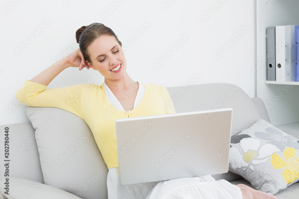 Smiling casual woman using laptop at home Smiling casual woman using laptop at home