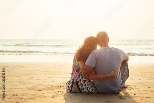 loving happy couple sitting on the beach. Romantic vacation happy honeymoon