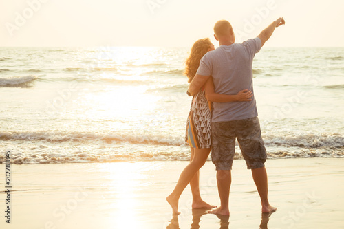 loving happy couple walking along the beach. Romantic vacation happy honeymoon