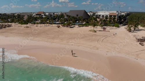 Tropical beach and waves with hotel in background