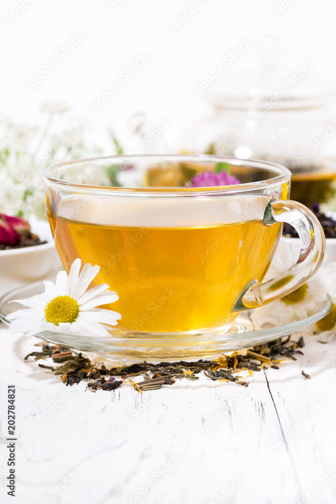fragrant herbal tea in a cup on white background, vertical