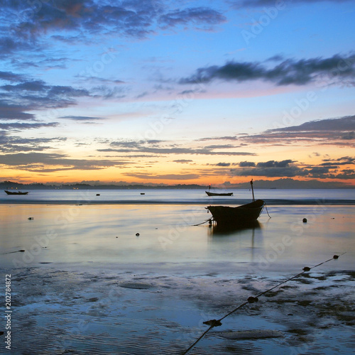 Fishing boat in the sea at sunrise