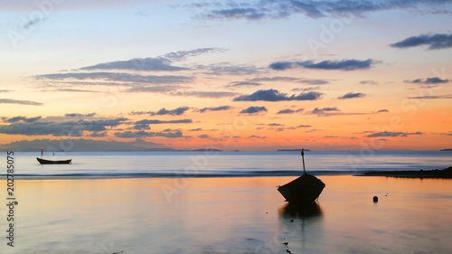 Fishing boat in the sea at sunrise