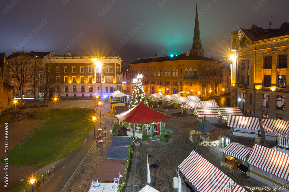 Fototapeta premium Aerial view of the decorated and illuminated Christmas tree, Christmas Market on the Cathedral Square, Doma laukums, Riga, Latvia.