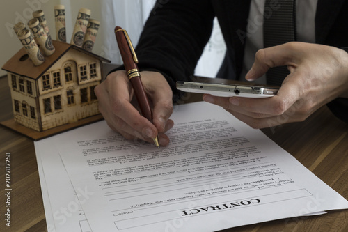 the man signs the real estate contract.