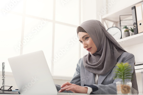 Arabic businesswoman in hijab working at office