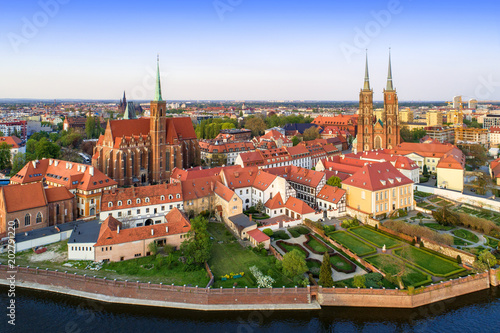 Poland. Wroclaw. Ostrow Tumski district with Gothic cathedral of St. John the Baptist,  Collegiate Church of the Holy Cross and St. Bartholomew and Odra (Oder) River. Aerial view in sunset light