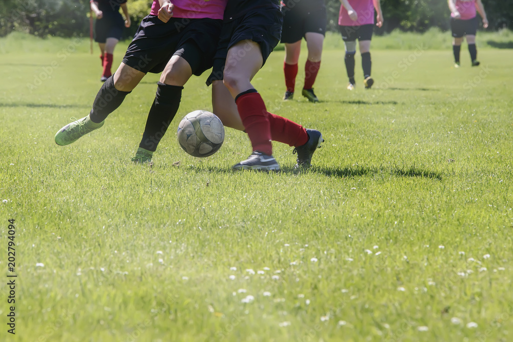 Football match of women's sports teams on a green football field Football match of women's sports teams on a green football field