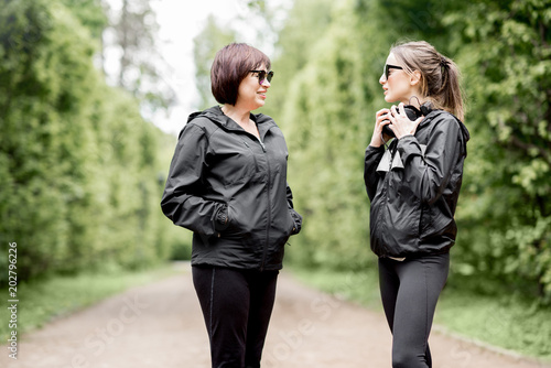 Two sports women talking in the park