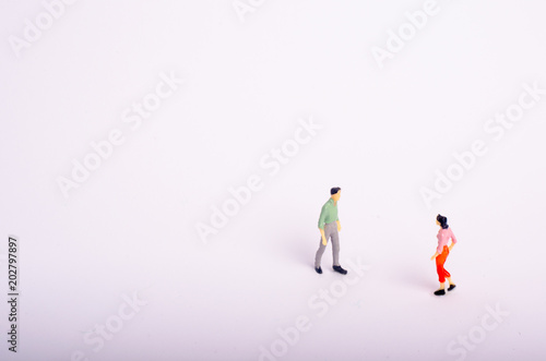 Meeting of two people on a white background. A man and a woman go to meet each other. Romantic relationship, love meeting, business meeting. Important conversation, dialogue, interview.