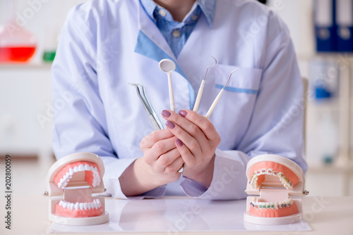 Dentist practicing work on tooth model