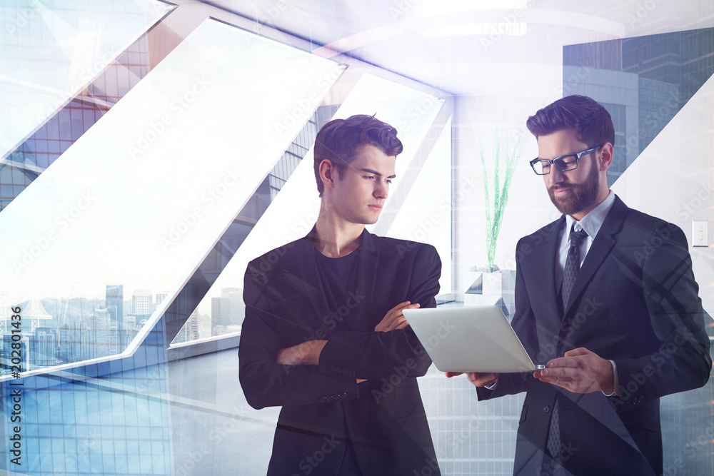 Businessmen using laptop in office Businessmen using laptop in office