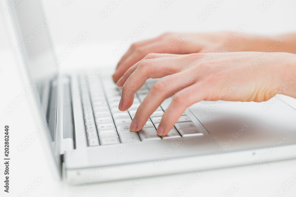Close up of hands typing on laptop keyboard Close up of hands typing on laptop keyboard