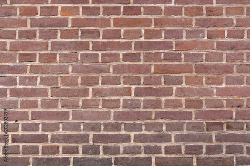 Background of old vintage dark red brick wall