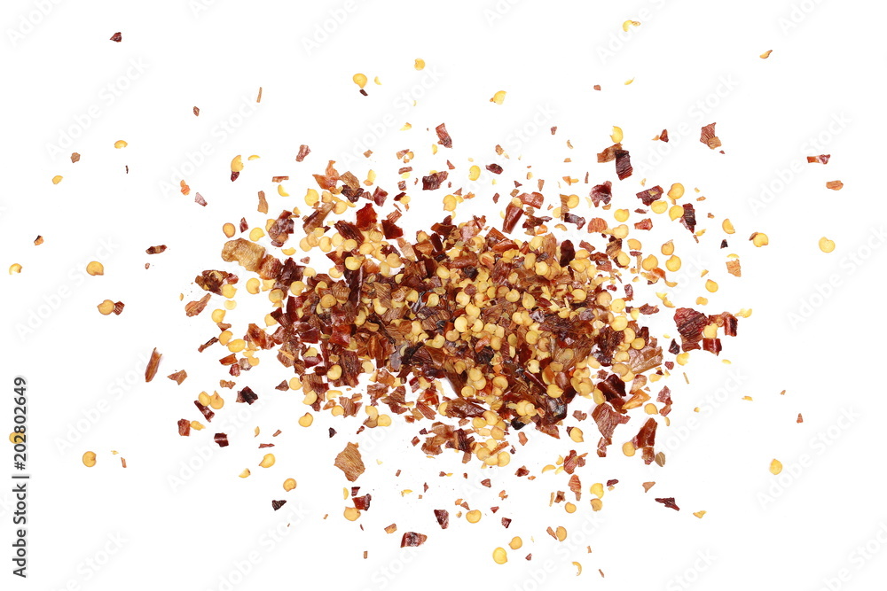 Pile crushed red cayenne pepper, dried chili flakes and seeds isolated on white background, top view