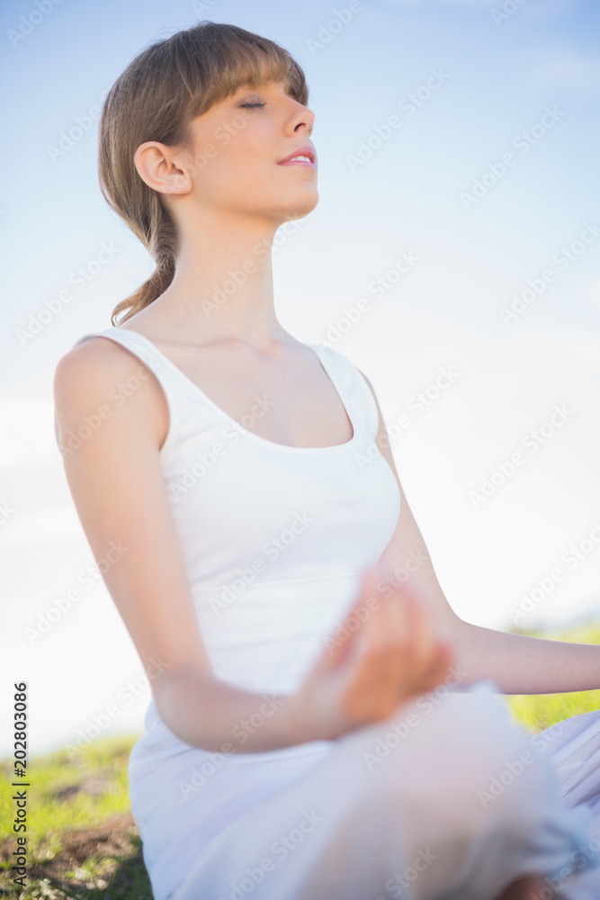 Peaceful young woman relaxing in yoga position Peaceful young woman relaxing in yoga position