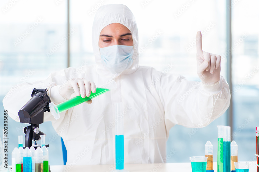 Young chemist pressing virtual buttons in lab Young chemist pressing virtual buttons in lab