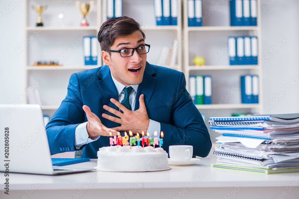 Young businessman celebrating birthday alone in office Young businessman celebrating birthday alone in office