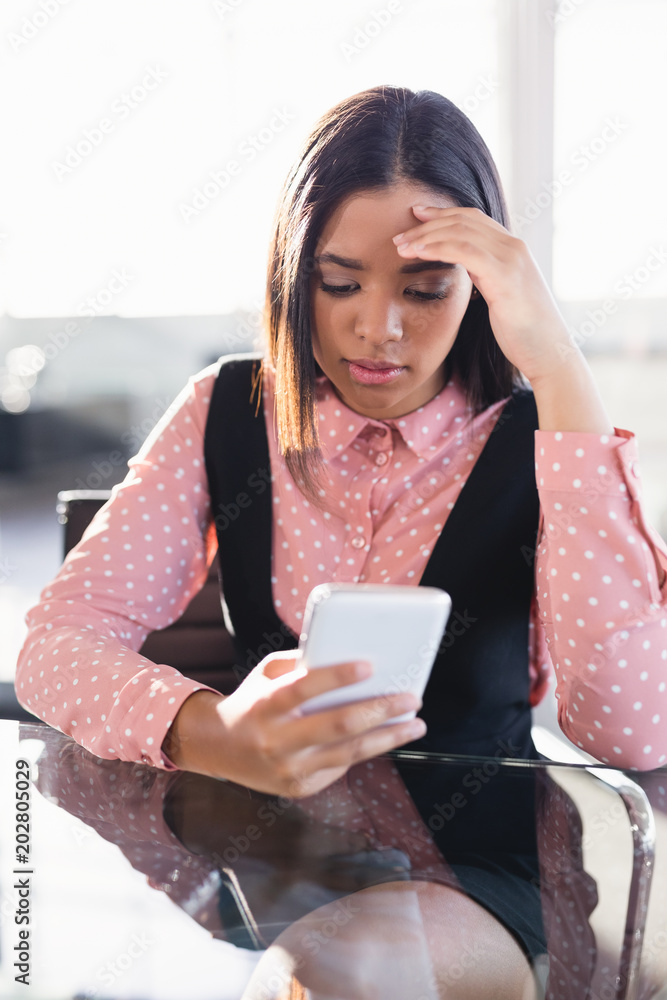Worried businesswoman using mobile phone Worried businesswoman using mobile phone