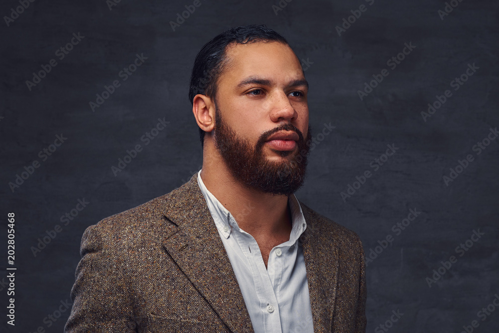 Handsome bearded African-American businessman in a brown classic jacket. Handsome bearded African-American businessman in a brown classic jacket.
