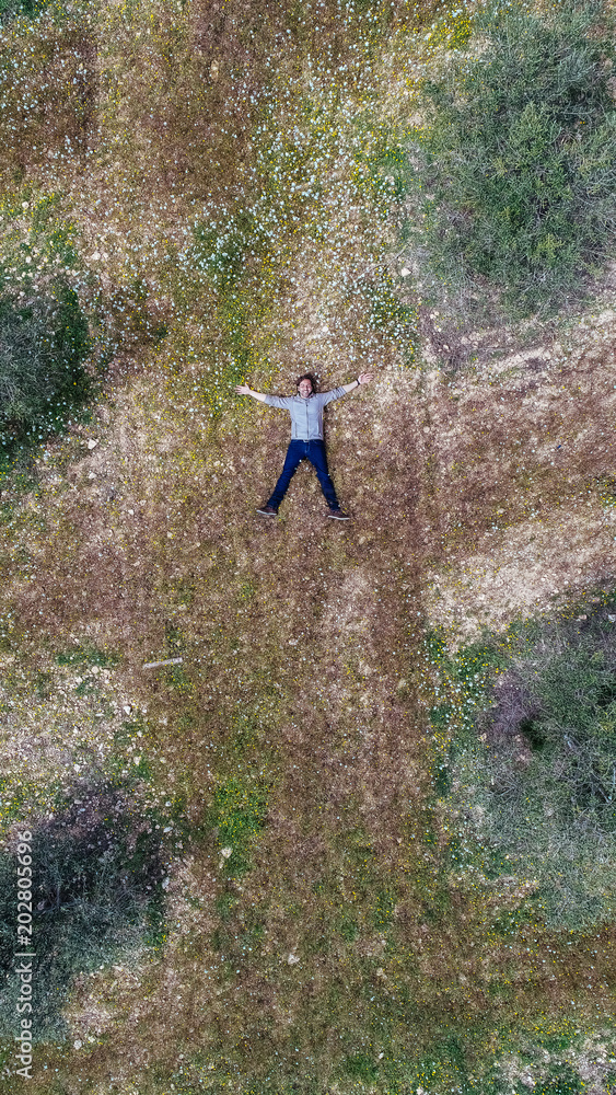 Aerial view of a man lying in a field Aerial view of a man lying in a field