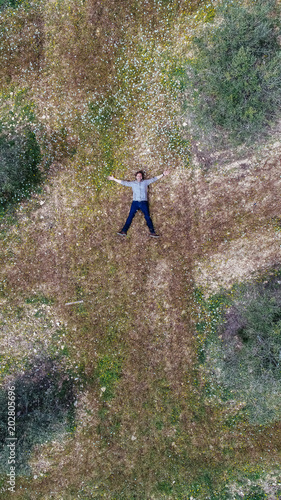 Aerial view of a man lying in a field