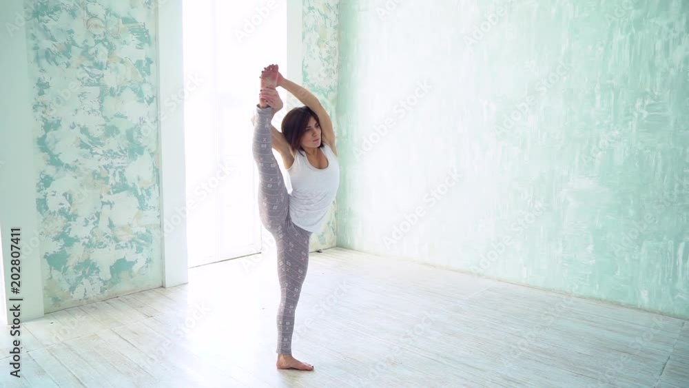 Woman practicing yoga in a studio indoors. slow-motion Woman practicing yoga in a studio indoors. slow-motion
