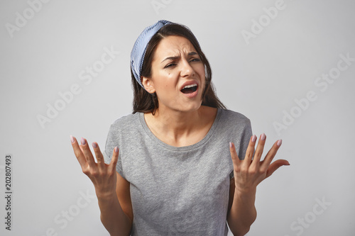 Photography Beautiful dark haired young European woman frowning and gesturing emotionally, h