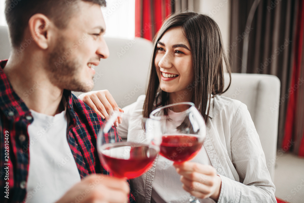 Love couple watches movie and drinks red wine Love couple watches movie and drinks red wine