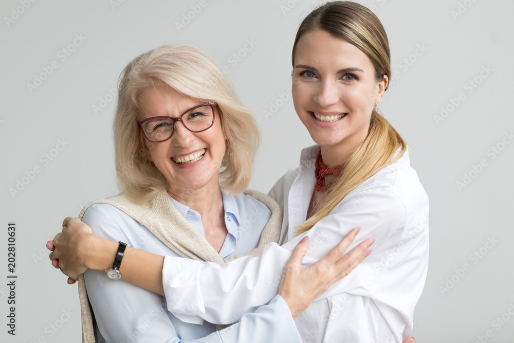 Φωτογραφία Happy attractive senior older aged mother and young adult daughter smiling laugh