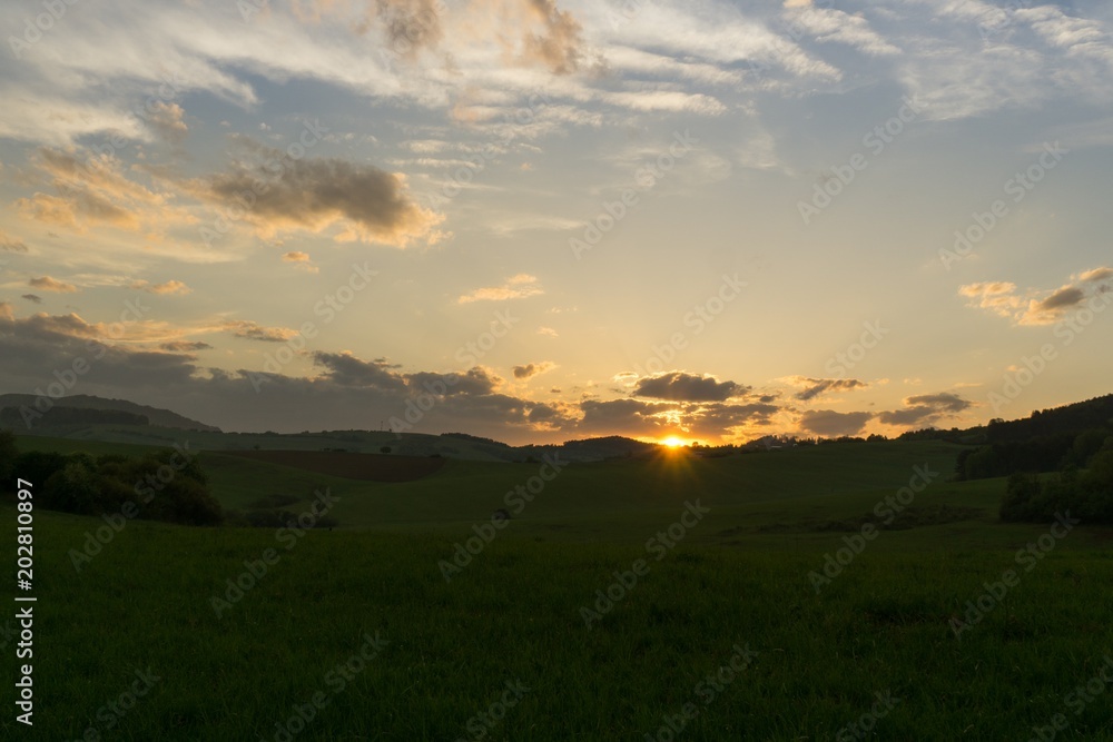 Fototapeta premium Sunset on meadow with hills and tree. Slovakia