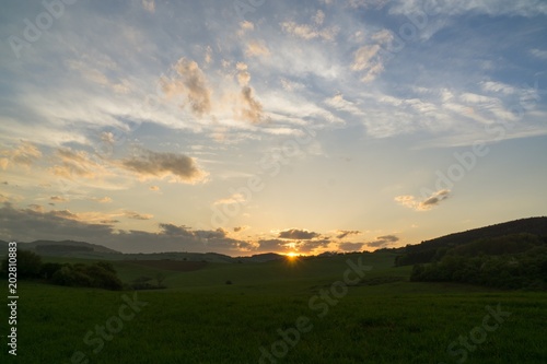 Sunset on meadow with hills and tree. Slovakia