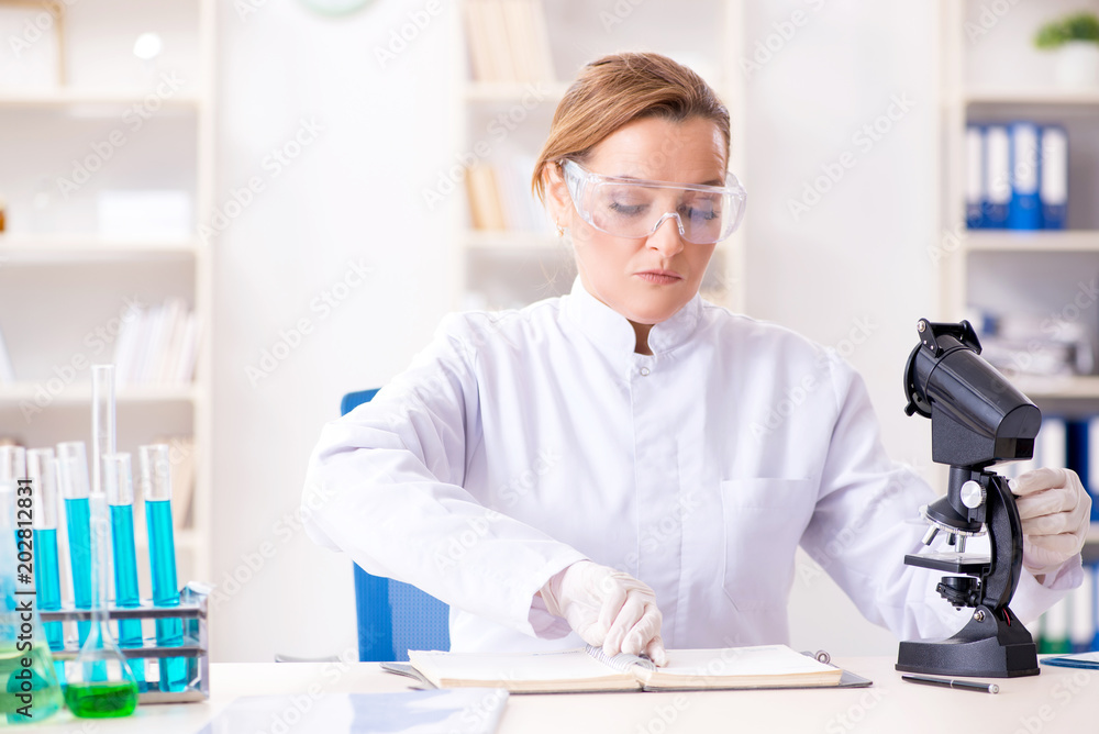 Woman chemist working in hospital clinic lab Woman chemist working in hospital clinic lab