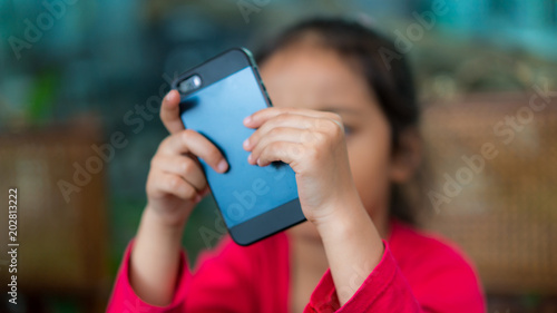 Little girl watching cartoon on smartphone
