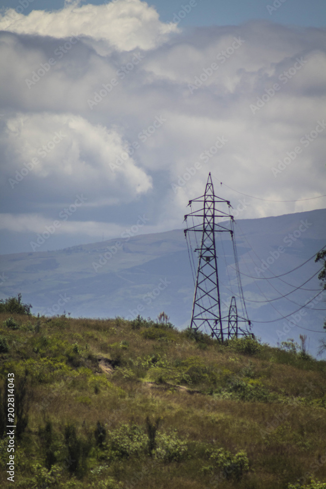 Electric tower made of metal in a mountainous area with the sky in the background. Industry concept Electric tower made of metal in a mountainous area with the sky in the background. Industry concept