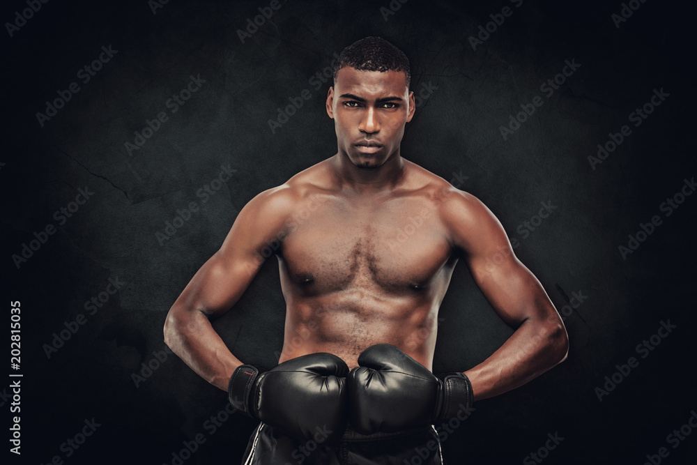 Muscular boxer against dark background