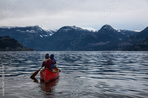 Adventurous people on a canoe are enjoying the beautiful Canadian Mountain Landscape. Taken in Squamish, North of Vancouver, British Columbia, Canada.