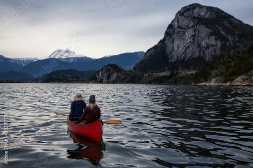 Adventurous people on a canoe are enjoying the beautiful Canadian Mountain Landscape. Taken in Squamish, North of Vancouver, British Columbia, Canada. © edb3_16