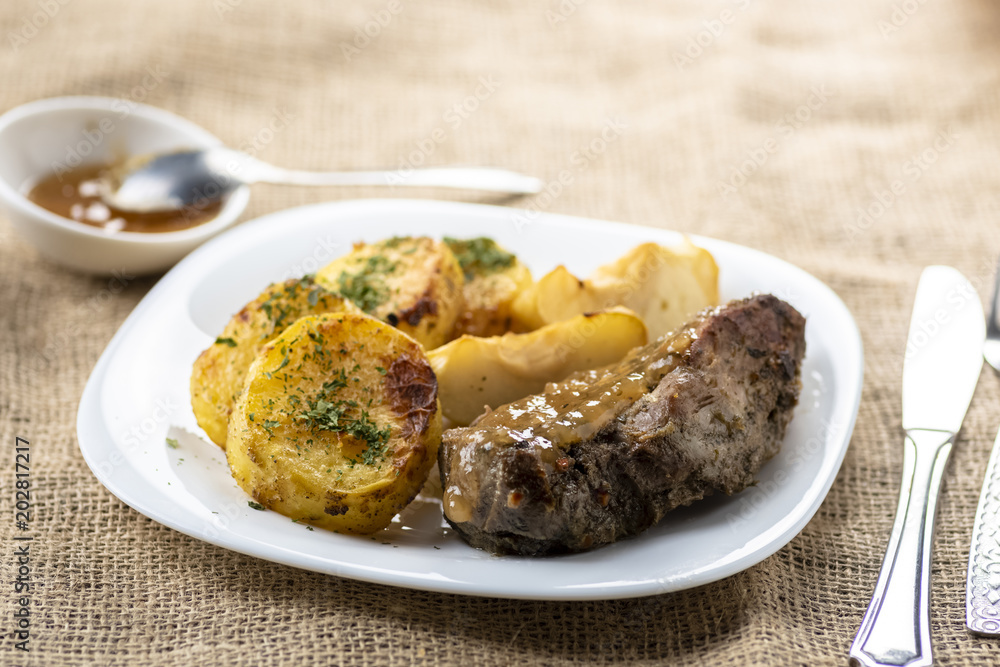 Duck fillet served with baked potatoes, apples and cranberries Duck fillet served with baked potatoes, apples and cranberries