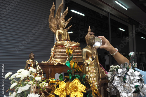 sprinkle water onto a Buddha in Songkran festival