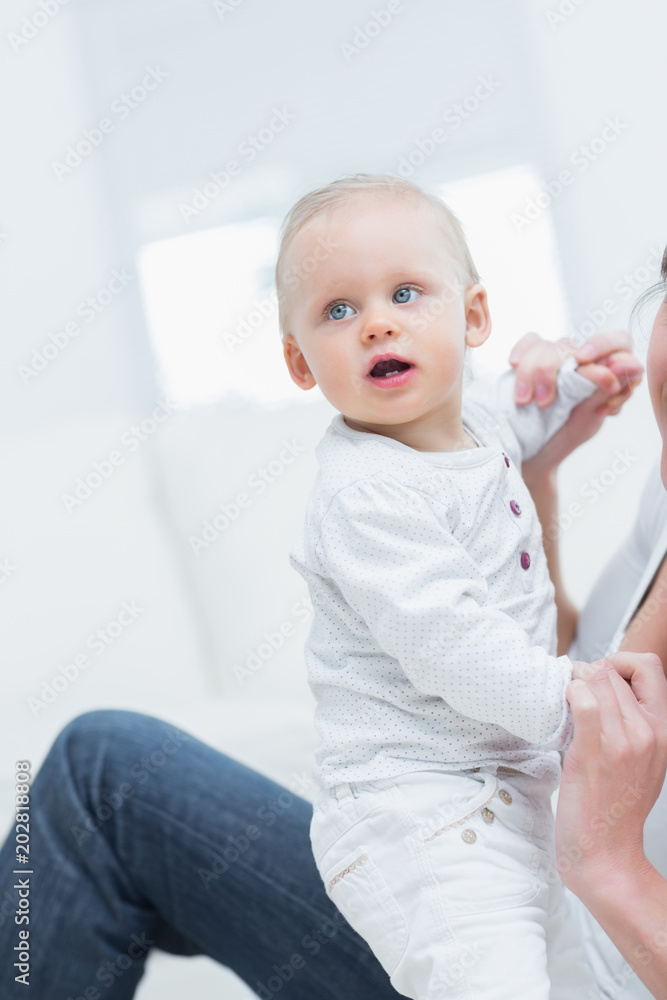 Mother holding a baby by his hands Mother holding a baby by his hands