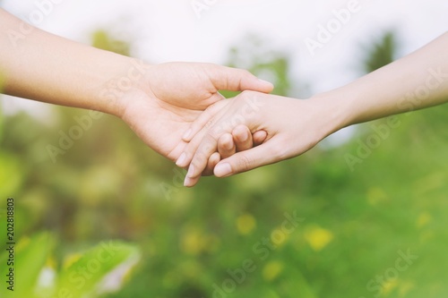 Woman and man holding hands, Happy couple love in the garden. concept couple lover valentine day. 